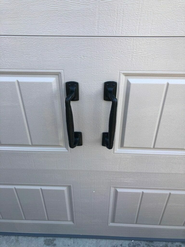 A closeup of garage door handles hardware
