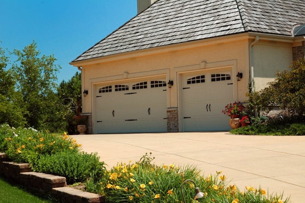 Two CHI Stamped Carriage House Garage Door installed in a garage.