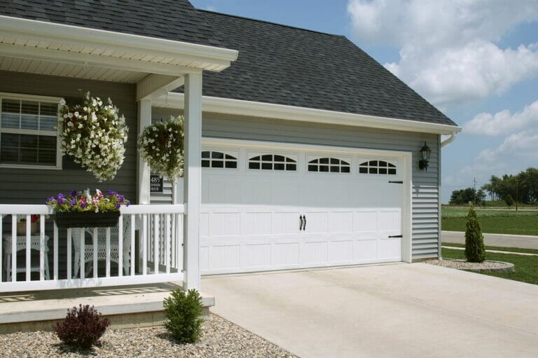A CHI Stamped Carriage House Garage Door Installed on a house