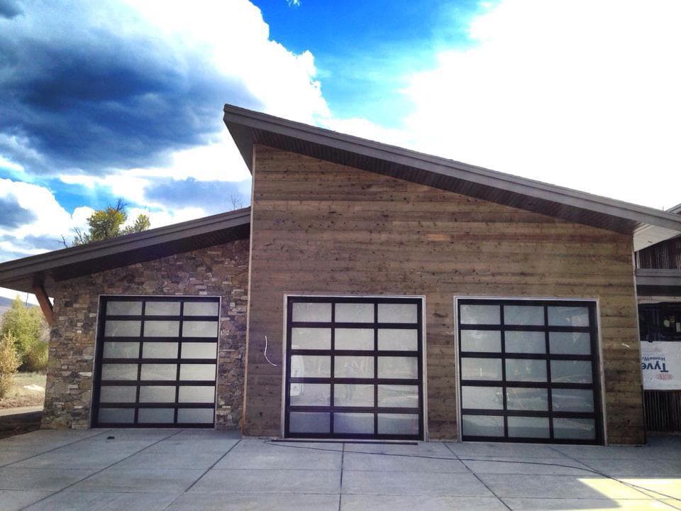 three full view garage doors installed in a garage.