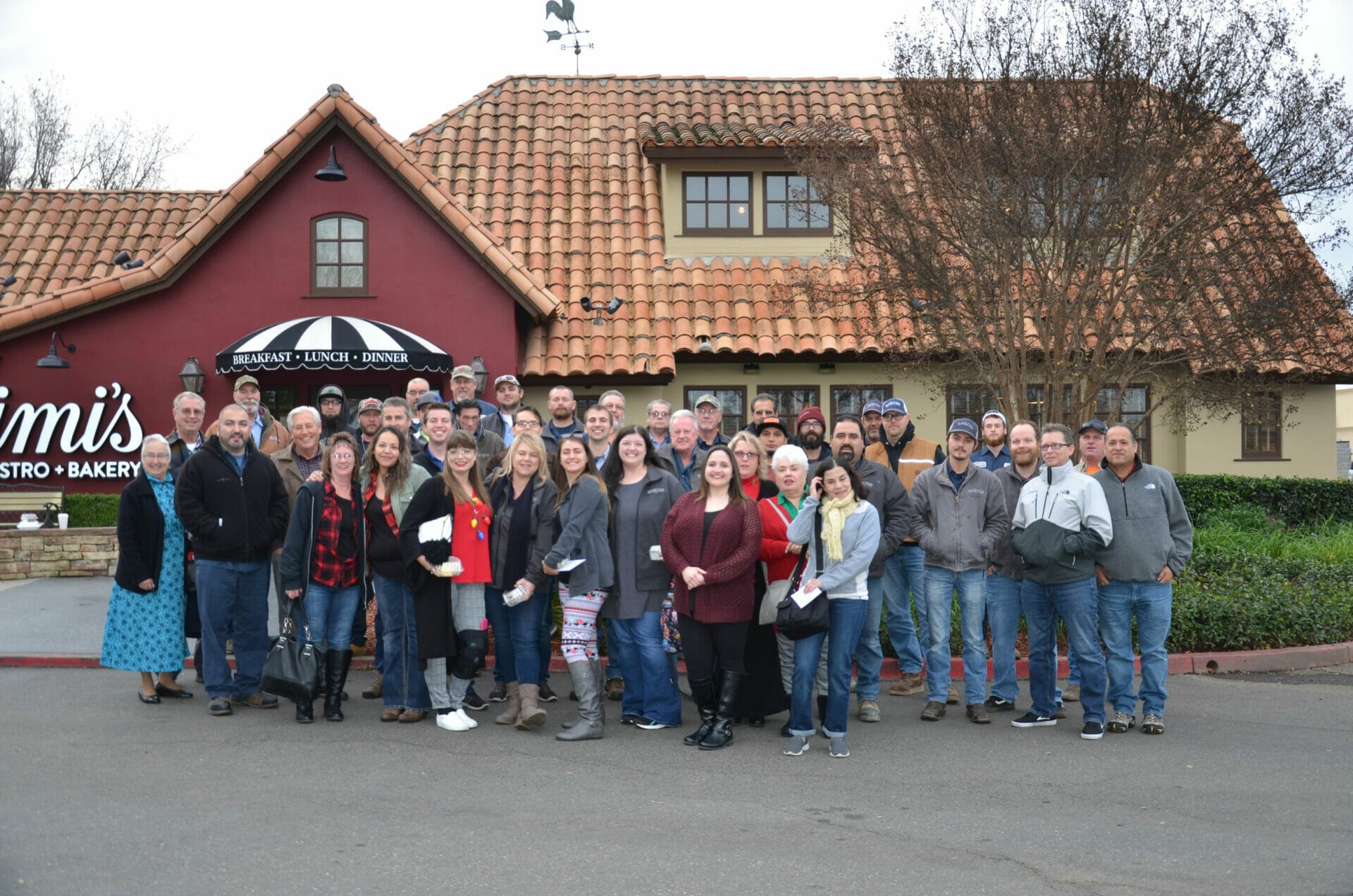 Most of Barton Overhead Doors employees standing in front of Mimi's cafe.