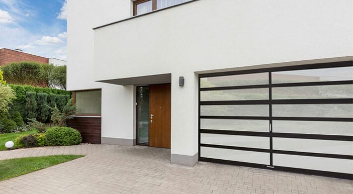 One Amarr Horizons Horizontal Glass Garage doors installed on a modern style house.