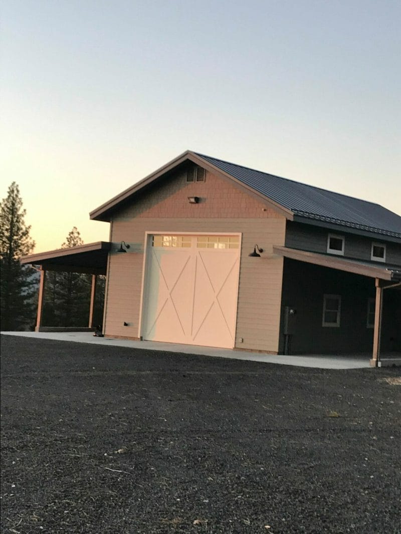 One Custom Carriage House Door installed on the back of a shop.