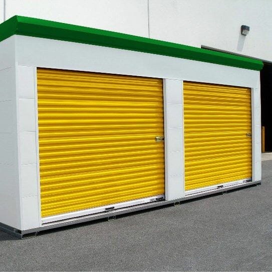 Two yellow self storage doors on a small shed.