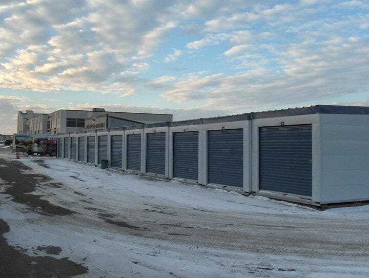 Janus self storage doors in a row with snow on the ground.