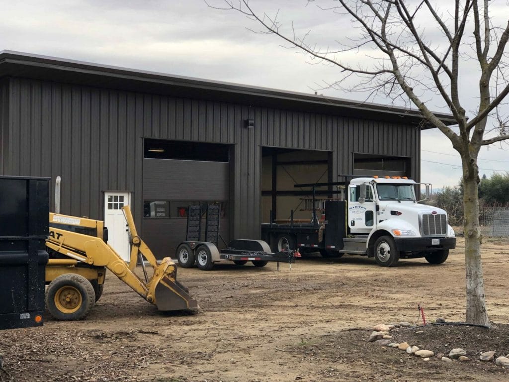 two doors being installed in an oakdale shop with a barton truck in the foreground.