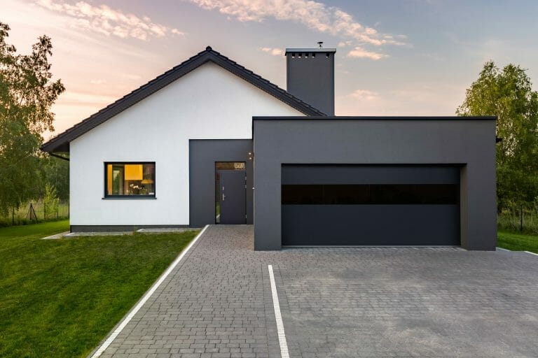 black and white home with a glass garage door.
