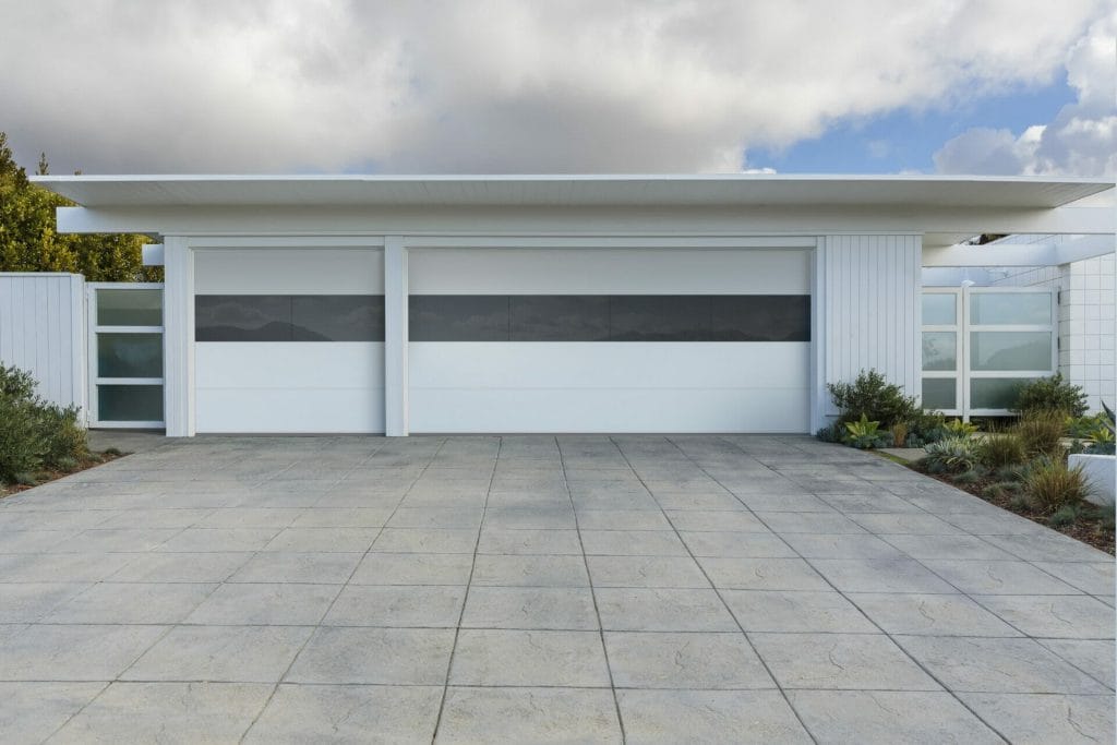 Contemporary white garage doors with a edge to edge glass panel.