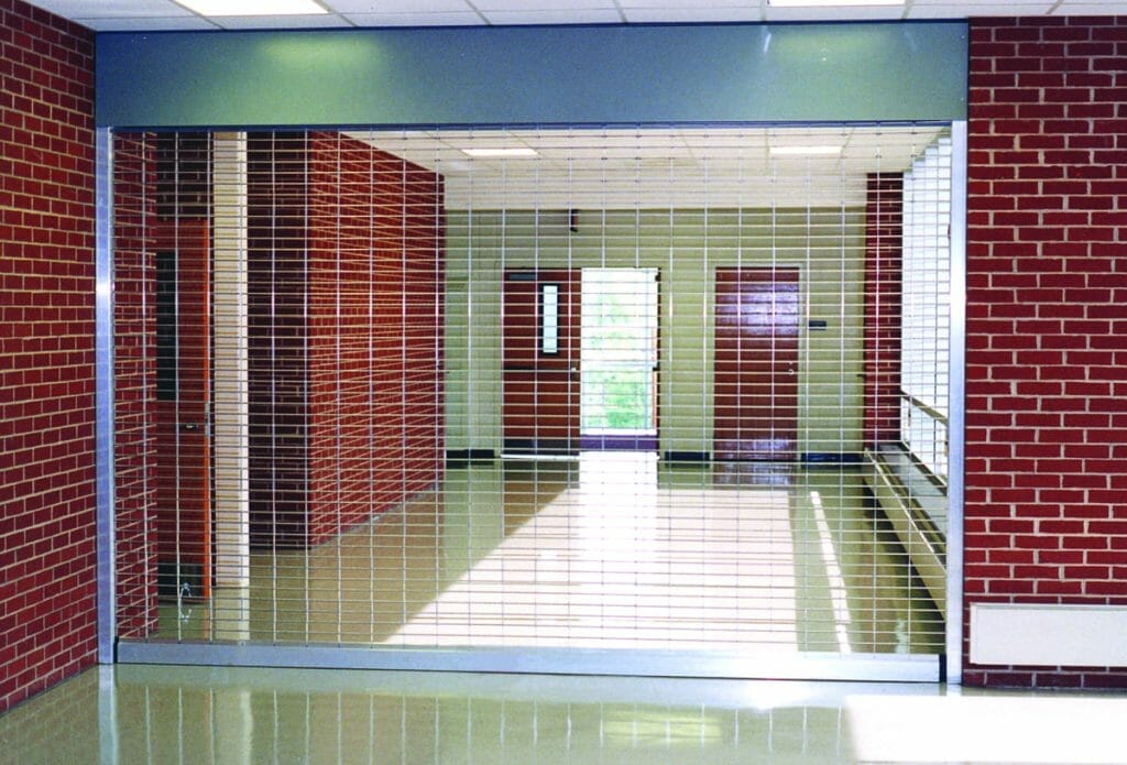 A hallway with a closed security grille.