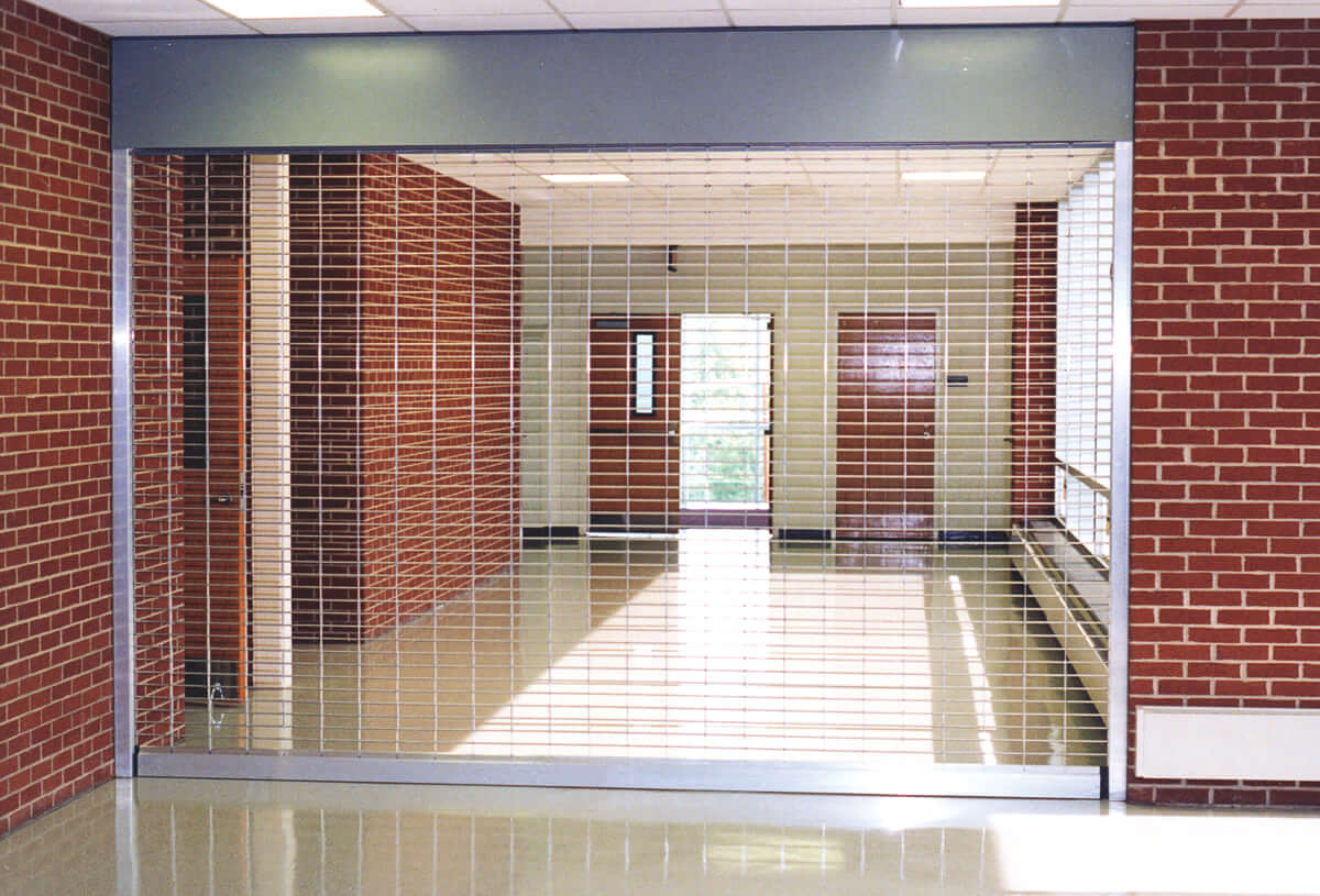 A hallway with a closed security grille.